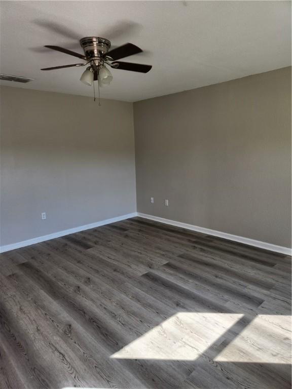 413 S 13th St, Aransas Pass, TX 78336 - unfurnished room featuring dark wood-type flooring, ceiling fan, and baseboards