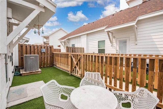 exterior space with central AC unit and a patio area