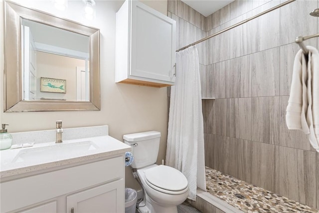 bathroom with a shower with curtain, vanity, and toilet