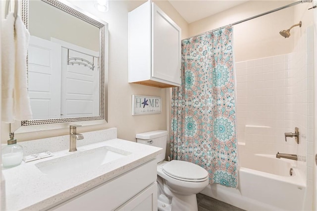 full bathroom with shower / tub combo with curtain, vanity, and toilet