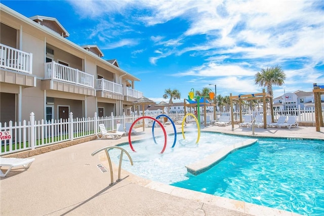 view of pool with a playground