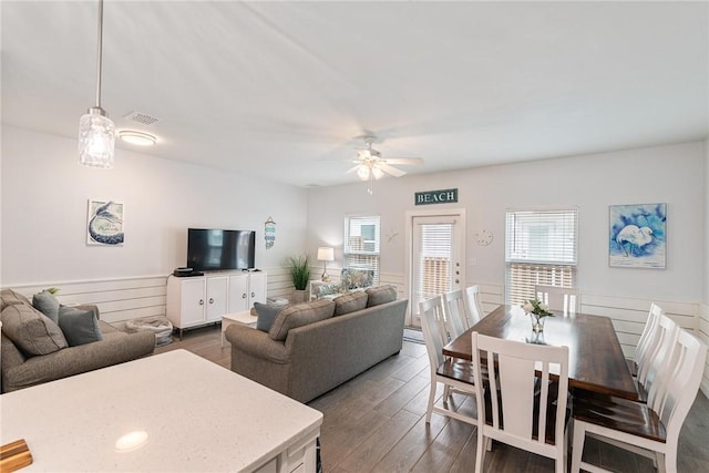 living room featuring dark wood-type flooring and ceiling fan