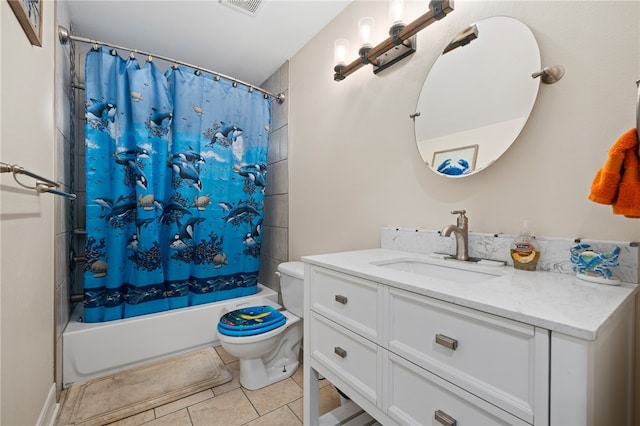 full bathroom featuring shower / bath combo with shower curtain, tile patterned flooring, vanity, and toilet