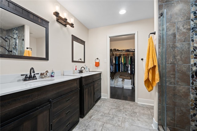 bathroom with vanity and a tile shower