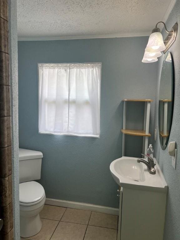 bathroom with vanity, crown molding, tile patterned flooring, toilet, and a textured ceiling