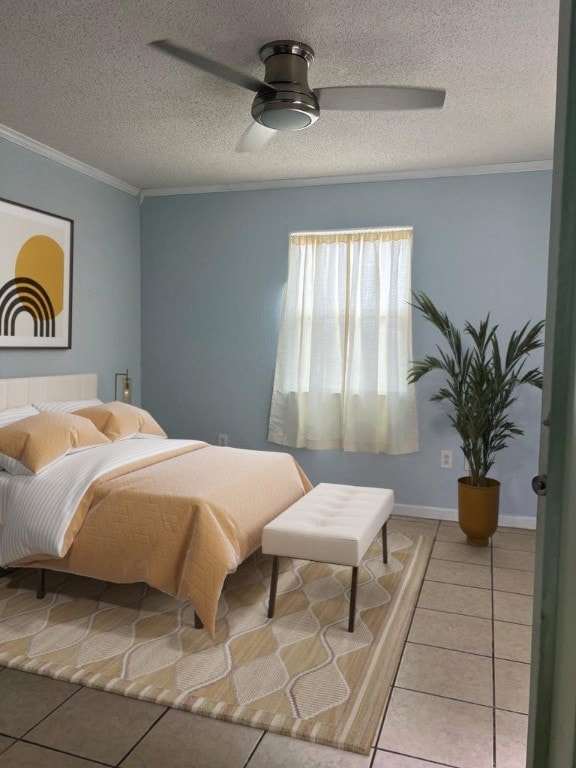 tiled bedroom with ceiling fan, ornamental molding, and a textured ceiling