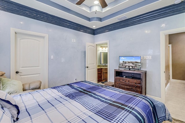 carpeted bedroom with ceiling fan, ensuite bath, and ornamental molding