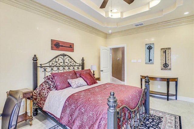 tiled bedroom featuring ornamental molding, ceiling fan, and a tray ceiling