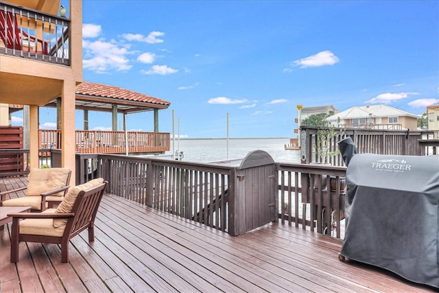 deck featuring a water view and grilling area