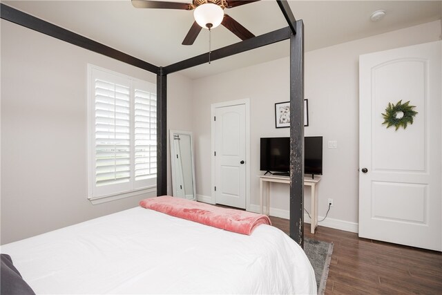 bedroom with ceiling fan and dark hardwood / wood-style flooring