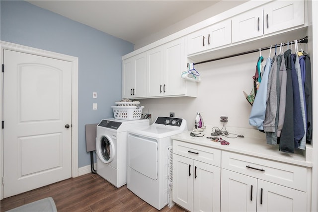 laundry area featuring cabinets, dark wood-type flooring, and washing machine and dryer