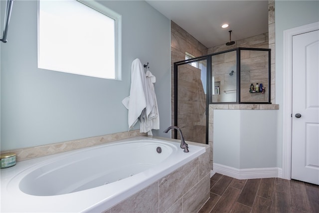 bathroom featuring hardwood / wood-style floors and shower with separate bathtub