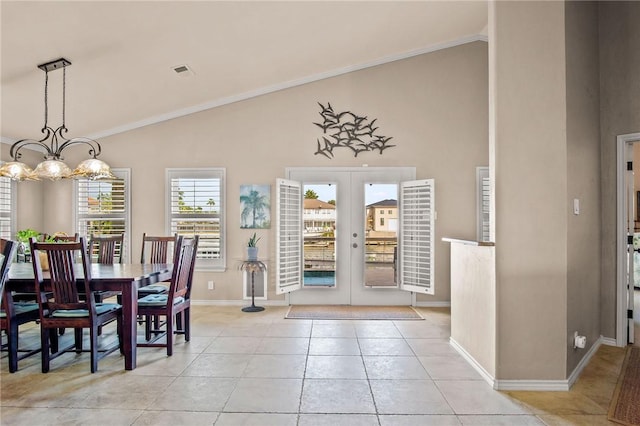 dining area featuring crown molding, light tile patterned floors, visible vents, french doors, and baseboards