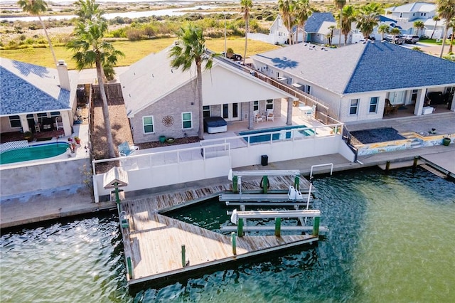 view of dock featuring an outdoor pool, a patio area, and a water view