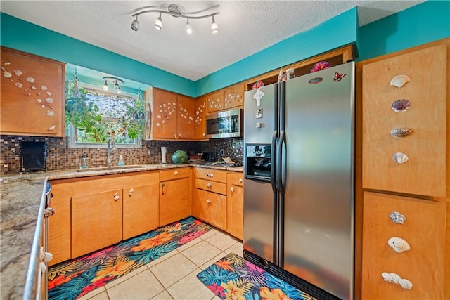 15718 Escapade St, Corpus Christi, TX 78418 - kitchen with appliances with stainless steel finishes, tasteful backsplash, light tile patterned flooring, brown cabinets, and light stone counters