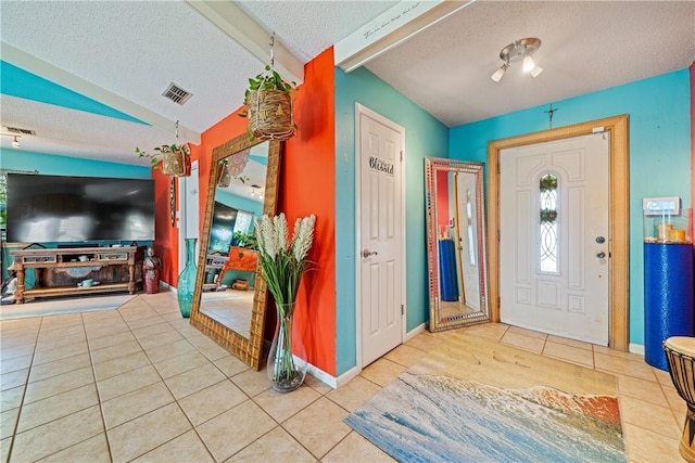 15718 Escapade St, Corpus Christi, TX 78418 - tiled entryway with a textured ceiling and lofted ceiling