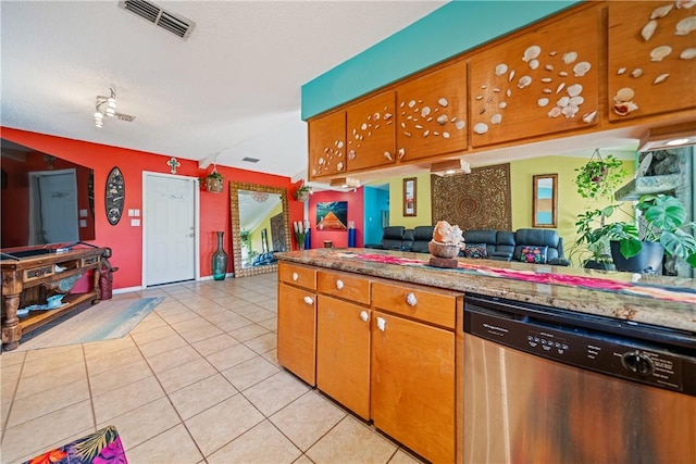 15718 Escapade St, Corpus Christi, TX 78418 - kitchen with dishwasher, light tile patterned flooring, brown cabinets, and open floor plan
