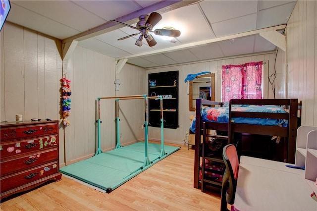 1162 N Sh 95, Bastrop, TX 78602 - bedroom with wood finished floors, wood walls, and a ceiling fan