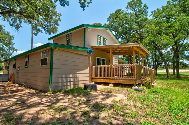 1162 N Sh 95, Bastrop, TX 78602 - rear view of house with a wooden deck and central AC unit