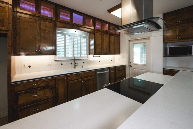 kitchen with island exhaust hood, plenty of natural light, sink, and appliances with stainless steel finishes