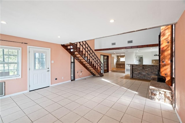 entryway with stairs, light tile patterned flooring, visible vents, and recessed lighting