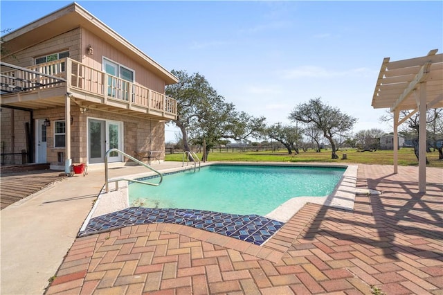 outdoor pool featuring french doors and a patio area