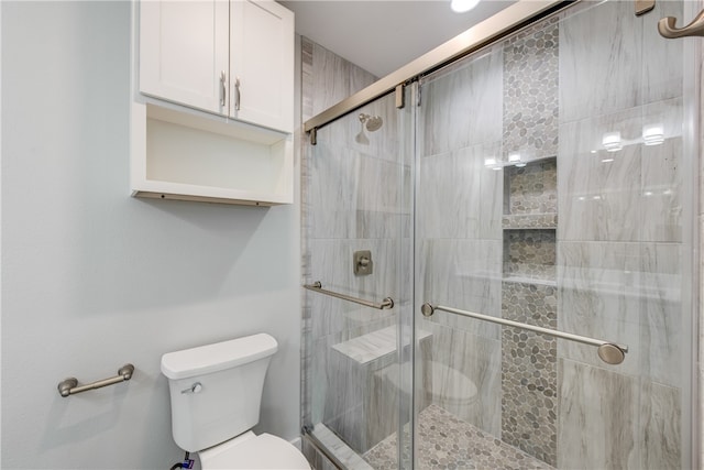 bathroom with an enclosed shower and toilet