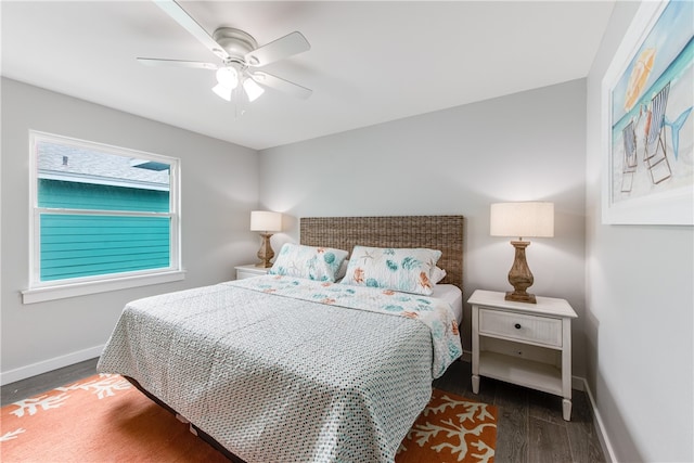 bedroom with dark hardwood / wood-style flooring and ceiling fan