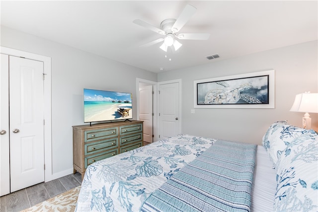 bedroom with a closet, ceiling fan, and light hardwood / wood-style flooring