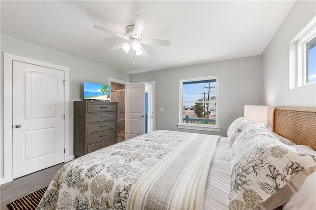 bedroom featuring hardwood / wood-style floors, ceiling fan, and multiple windows