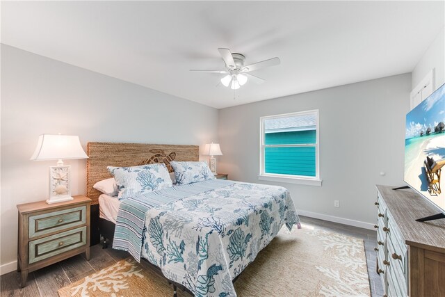 bedroom with ceiling fan and dark hardwood / wood-style floors