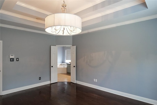 5710 Neustadt Dr, Corpus Christi, TX 78414 - unfurnished room featuring wood finished floors, baseboards, a raised ceiling, and crown molding