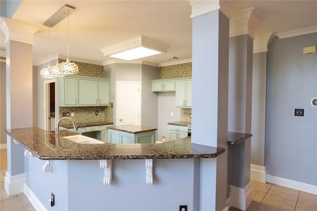 5710 Neustadt Dr, Corpus Christi, TX 78414 - kitchen featuring a sink, crown molding, light tile patterned floors, and decorative backsplash