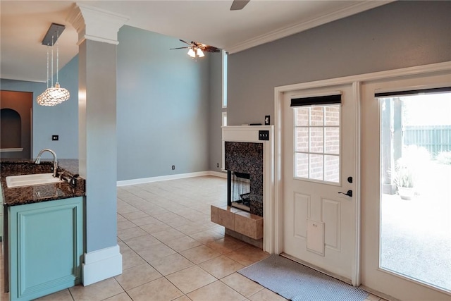 5710 Neustadt Dr, Corpus Christi, TX 78414 - living room featuring ceiling fan, ornamental molding, light tile patterned floors, a fireplace, and baseboards