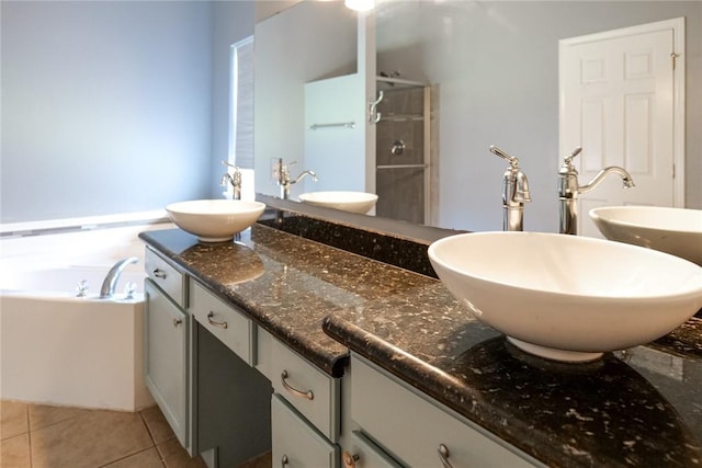 5710 Neustadt Dr, Corpus Christi, TX 78414 - bathroom featuring double vanity, a stall shower, tile patterned floors, and a garden tub