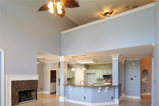 5710 Neustadt Dr, Corpus Christi, TX 78414 - kitchen with a ceiling fan, appliances with stainless steel finishes, dark stone counters, tasteful backsplash, and a peninsula