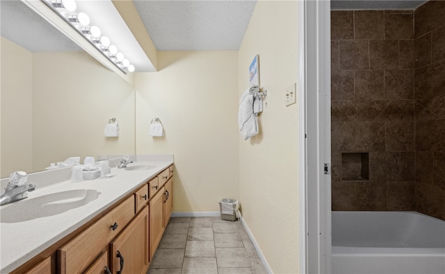 bathroom with a textured ceiling, vanity, and tile patterned floors