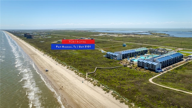 drone / aerial view featuring a water view and a view of the beach