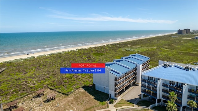 drone / aerial view featuring a beach view and a water view