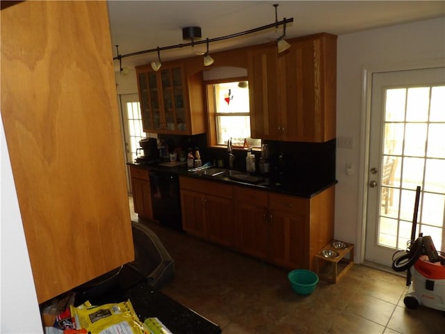 170 Barker Rd, Bayside, TX 78340 - kitchen featuring dishwasher, brown cabinets, dark countertops, and glass insert cabinets