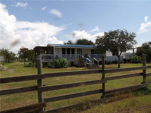 170 Barker Rd, Bayside, TX 78340 - view of front of house featuring a porch, a fenced front yard, and a metal roof