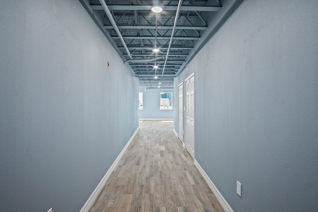 corridor with wood-type flooring