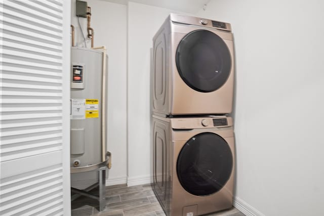 laundry room with stacked washing maching and dryer, water heater, and wood-type flooring