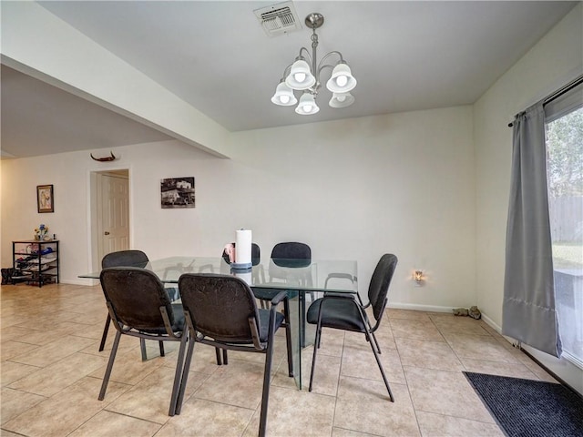 tiled dining area featuring a chandelier