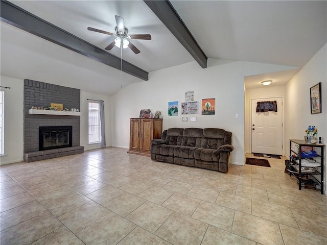 living room featuring vaulted ceiling with beams, a brick fireplace, ceiling fan, and light tile patterned flooring