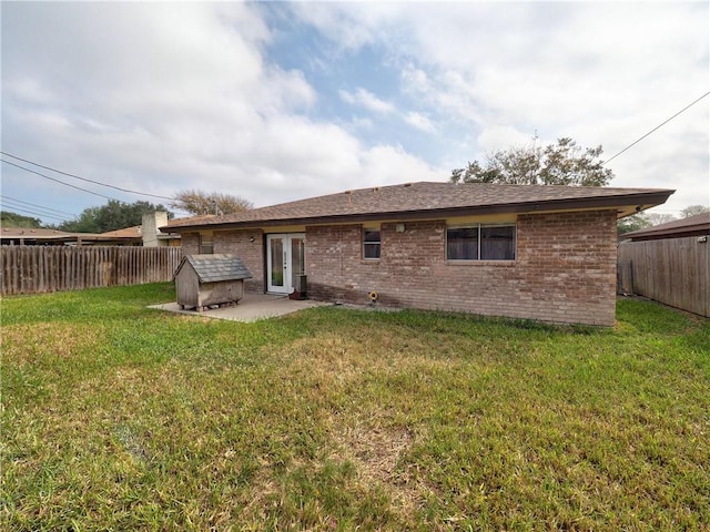 back of property featuring a lawn and a patio area