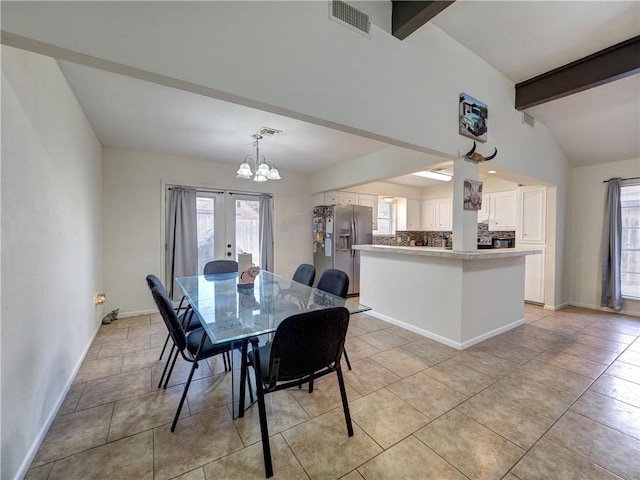 tiled dining space featuring a notable chandelier, lofted ceiling with beams, and french doors