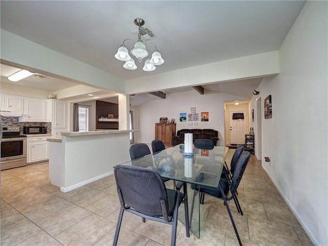 tiled dining space featuring lofted ceiling with beams and a notable chandelier