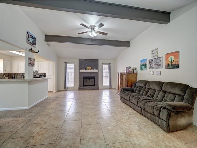 living room featuring ceiling fan, a fireplace, light tile patterned floors, and lofted ceiling with beams