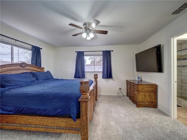 carpeted bedroom featuring ensuite bathroom and ceiling fan